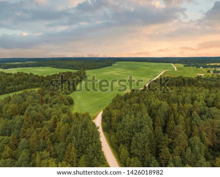 Similar – A tranquil aerial view of a lush golf course fairway, bathed in the warm glow of sunset. Ideal for themes of relaxation, nature, and sports, this image captures the peaceful beauty of the golfing experience.