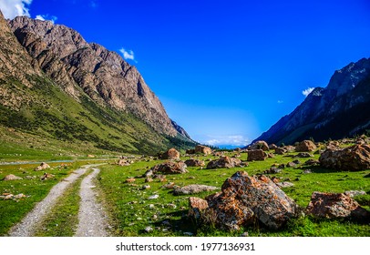The road through the mountain valley. Mountain valley landscape. Mountain valley rocks