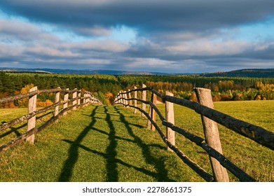 The road to the top of the mountain is fenced with wooden handrails - Shutterstock ID 2278661375