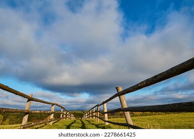 The road to the top of the mountain is fenced with wooden handrails - Shutterstock ID 2278661425