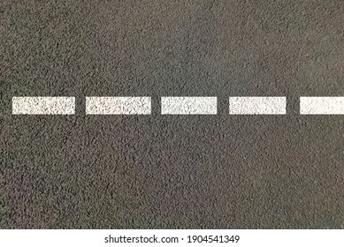 Road Top View With Lines Painted In White Colour Dash Across Length Of Road , Dividing Lines For Both Side Traffic On Highway