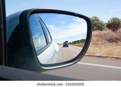 road and traffic in the car rearview mirror road trip - Powered by Shutterstock