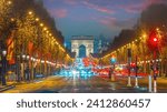 Road  and traffic of Champs Elysee leading to Arc de Triomphe in Paris, France at night