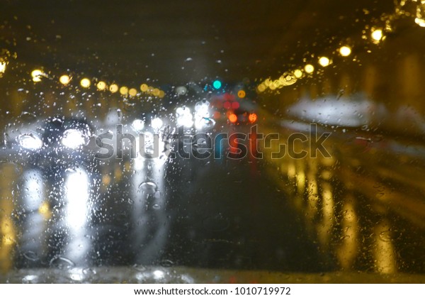 Road traffic in rainy night tunnel with cars and\
lights blur effect