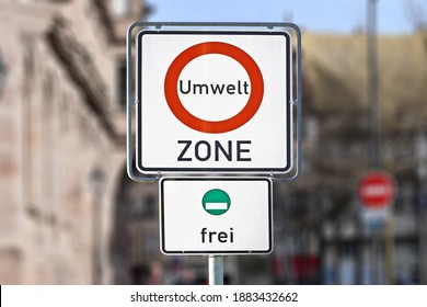Road traffic sign marking a low emission zone in city centers in Germany translating as "Environmental Zone" and sign showing cars with green environmental badge a free to enter - Shutterstock ID 1883432662