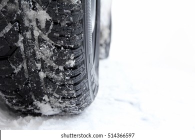 Road traffic in winter. Winter tire on a car in the snow