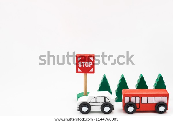 Road traffic with wooden toy cars in the\
town on white background, safety and traffic regulations concept,\
backgrounds.Transportation system\
concept