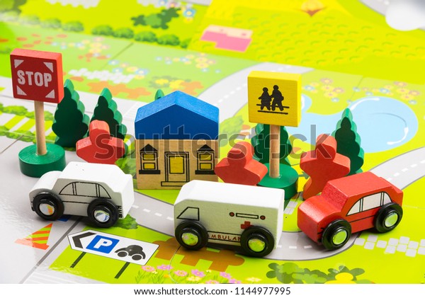 Road traffic with wooden toy cars in the\
town on white background, safety and traffic regulations concept,\
backgrounds.Transportation system\
concept