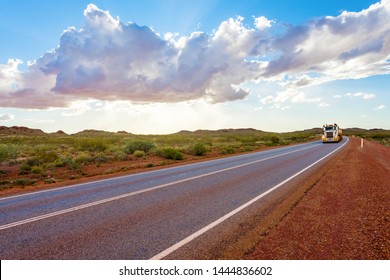 Road train with unbranded carriages on Australian outback highway. Pilbara mining region, Western Australia.