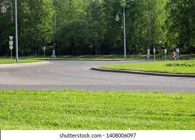 Road for transport with road signs among green grass