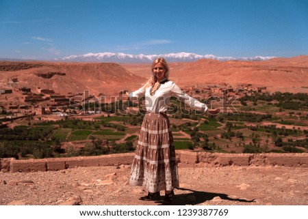 Road trip around Morocco, girl posing in front of the panoramic view of the High Atlas Mountains, North Africa