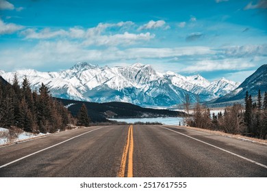 Road trip with car driving on highway road with snow covered rocky mountains in winter at Kootenay plains area, Alberta, Canada - Powered by Shutterstock