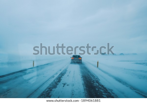 Road trip\
with car in front winter season\
Iceland