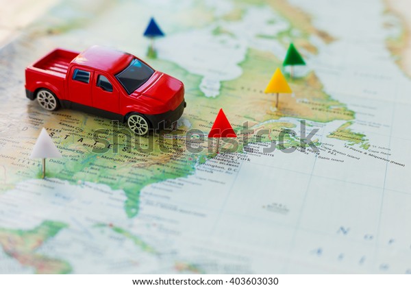 Road trip - car goes on\
map across the territory of the USA. The route of automobile travel\
is laid by office pins. Planning active vacation, interesting\
journey.