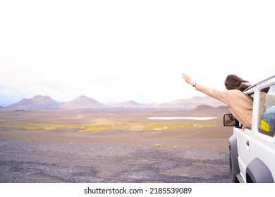 Road Trip Car Holiday Happy Couple Driving Jeep Car On Summer Travel Iceland Vacation. Woman With Arms Up Having Fun. Freedom Concept