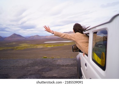 Road Trip Car Holiday Happy Couple Driving Jeep Car On Summer Travel Iceland Vacation. Woman With Arms Up Having Fun. Freedom Concept