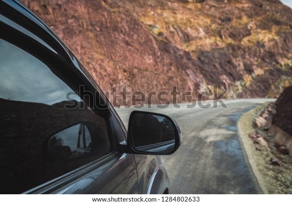 Road trip concept\
, Black Four-wheel drive or 4WD car travel on the off-road with\
mountain road background