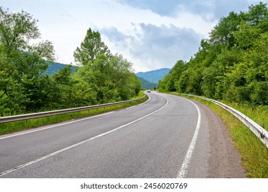 Road trip in green Carpathian mountains. Winding asphalt road - Powered by Shutterstock