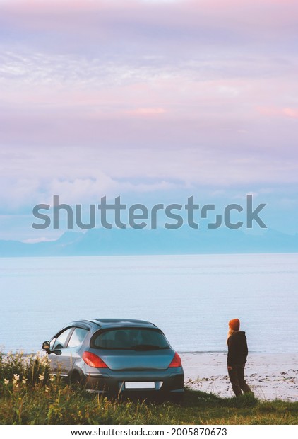 Road trip in Norway woman traveling by rental\
car adventure lifestyle concept vacations camping outdoor sunset\
mountains and fjord\
landscape