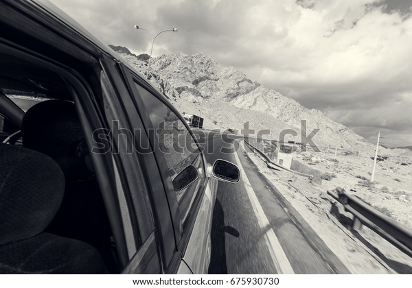 A road trip point of view of a road and car on a
highway desert, point of view from someone hanging out of a window.
Travel is freedom.