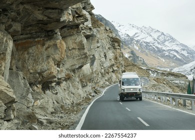 Road trip through Manali Leh Ladak highway in Himalayas India. High altitude road in Kullu Manali Ladakh Himachal Pradesh. Beautiful snow covered Indian mountain