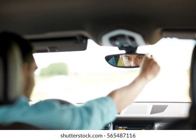 Road Trip, Transport And People Concept - Man Driving Car Adjusting Rearview Mirror