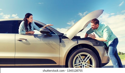 road trip, transport, travel and people concept - family couple with open hood of broken car at countryside - Powered by Shutterstock