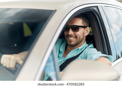 Road Trip, Transport, Travel And People Concept - Happy Smiling Man In Sunglasses Driving Car