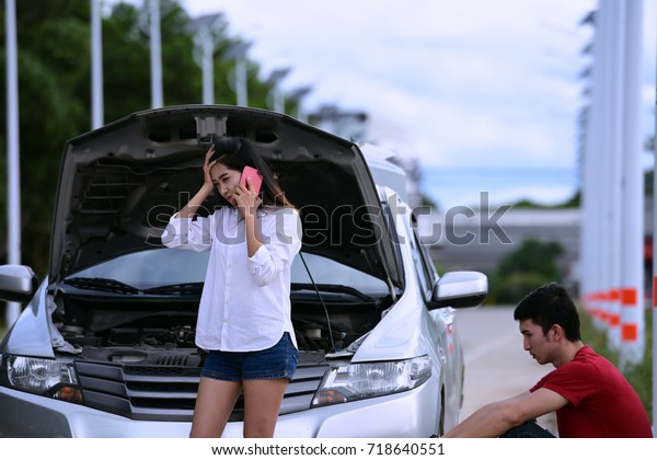 road\
trip, transport, travel, technology and people concept - close up\
of Couples are concerned when their car breaks\
down.