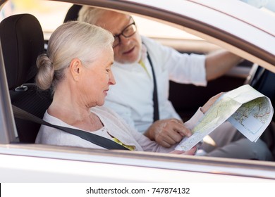 Road Trip, Travel And Old People Concept - Happy Senior Couple With Map Driving In Car