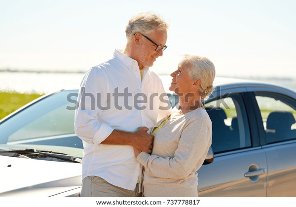 road trip, travel and old people concept - happy\
senior couple at car in\
summer