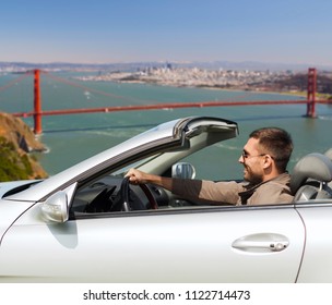 road trip, travel and people concept - happy man driving convertible car over golden gate bridge in san francisco bay background - Powered by Shutterstock