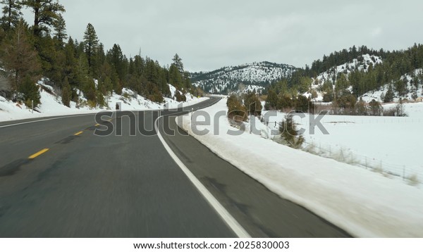 Road trip in USA from Zion to Bryce Canyon, driving
auto in Utah. Hitchhiking traveling in America, Route 89 to Dixie
Forest. Winter local journey, calm atmosphere and snow mountains.
View from car.