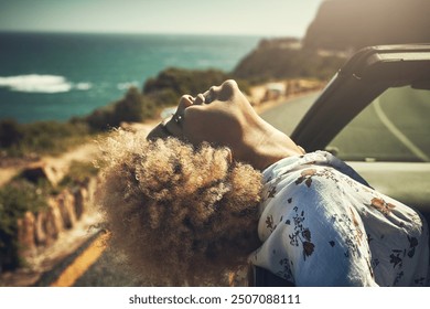 Road trip, woman and happy in car for freedom, journey and travel adventure in summer. Passenger, smile or drive at ocean for scenic route, vacation or peace on mountain road in vehicle for transport - Powered by Shutterstock