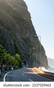Road with tunnel along Madeira coast, waterfall above the road - Shutterstock ID 2137329463