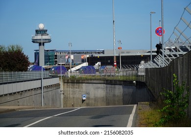 Road tunnel under a taxiway for aircrafts. Bright blue sky in northern Germany.             