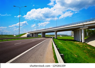 Road Under Construction. Freeway, Overpass And Junction With Green Grass