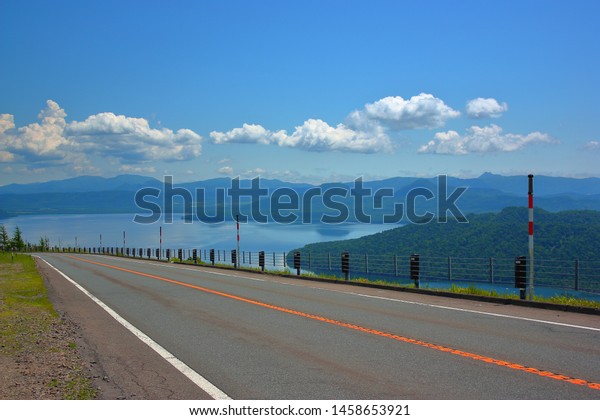 Road under fine weather. Landscape of the lake with\
blue sky.