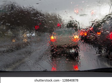 Road View Through Car Window With Rain Drops