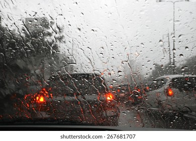 Road View Through Car Window With Rain Drops, Driving In Rain.