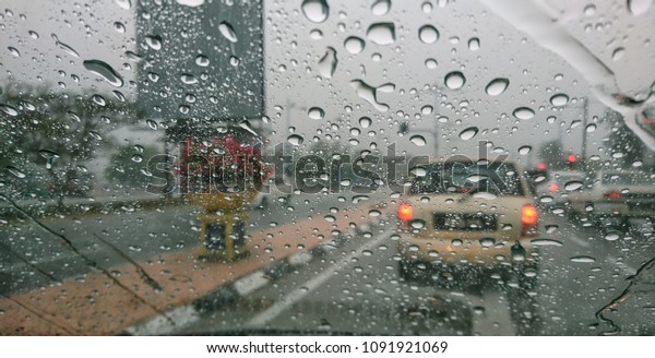 Road view
through car window blurry with heavy rain, Driving in rain, rainy
weather, rainy day, rain
background