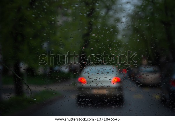 Road view through car window blurry with
heavy rain, Driving in rain, rainy
weather