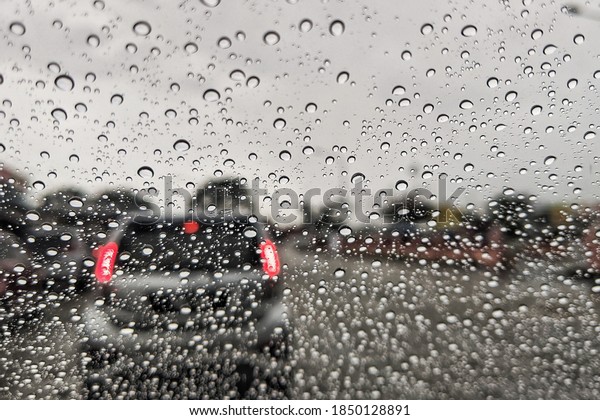 Road view through car
window blurry with heavy rain, Concept of driving in rain, bad
driving conditions.