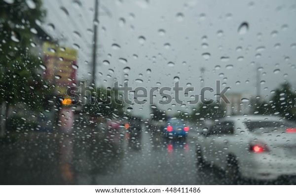 Road view through car window blurry with
heavy rain, Driving in rain, rainy
weather
