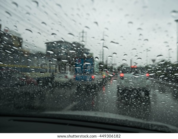 Road view through car window blurry with rain,
Driving in rain, rainy
weather