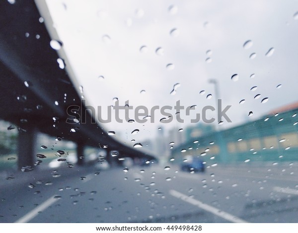 Road view through car window blurry with rain,\
Driving in rain, rainy\
weather