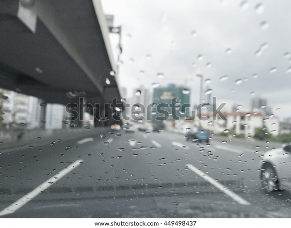 Road view through car window blurry with rain,\
Driving in rain, rainy\
weather