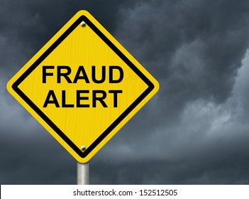 A road warning sign against a stormy sky with words Fraud Alert, Warning of Fraud