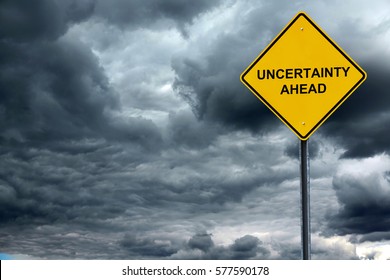 road warning sign with text uncertain ahead in front of storm cloud background - Shutterstock ID 577590178