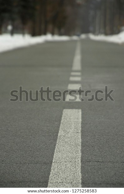Road with white\
dividing\
strip, asphalt\
road